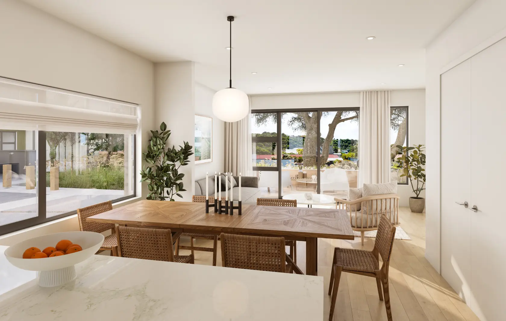 Open-plan kitchen and dining with island bench, rattan stools and light oak flooring
